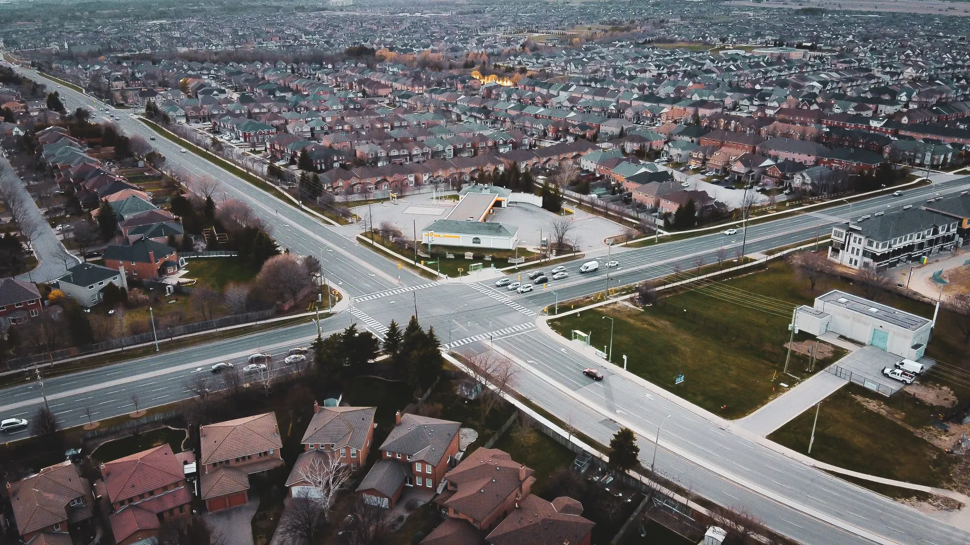 An aerial view of detached housing and arterial roads across the Greater Toronto Area