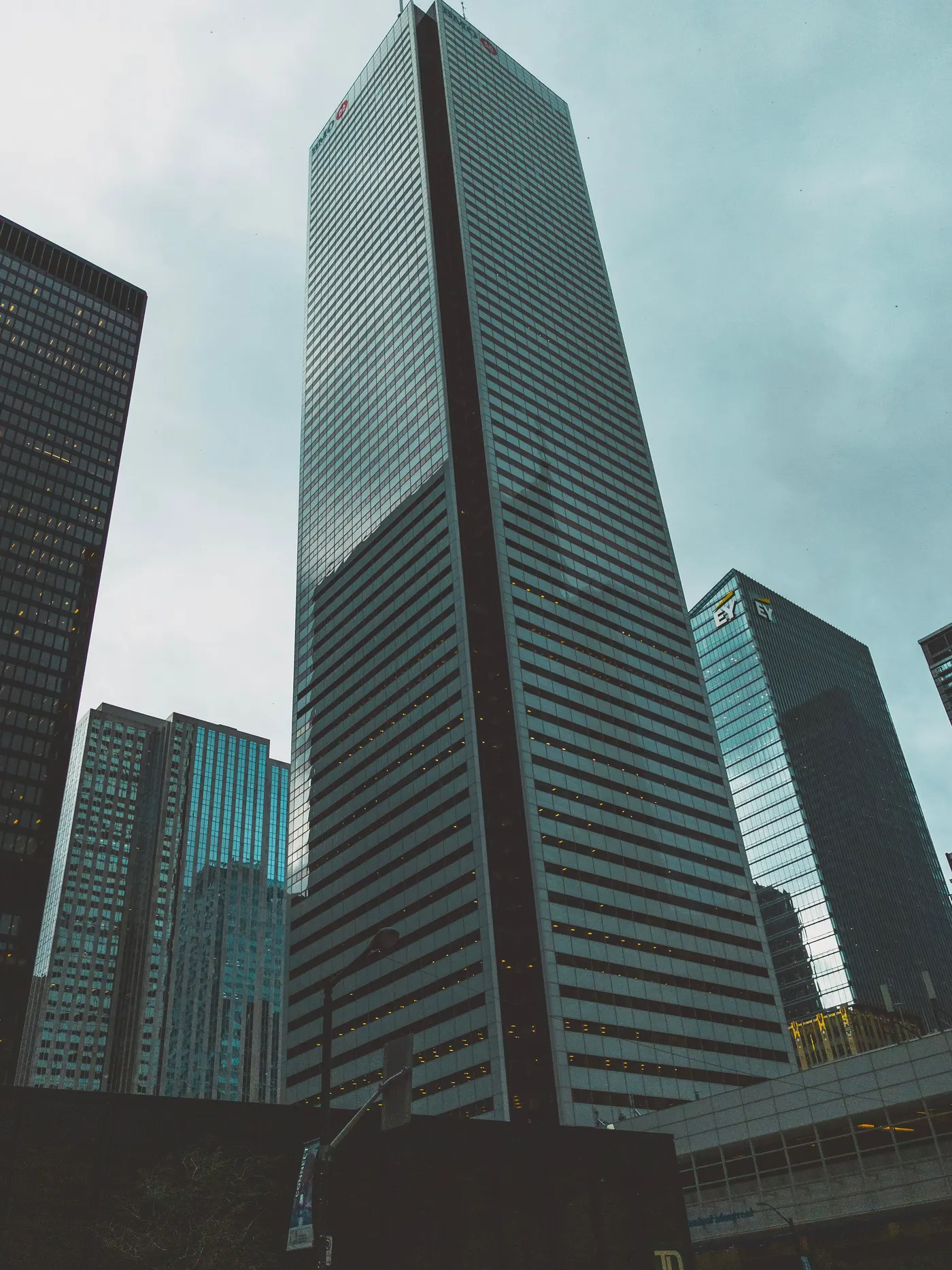 Looking up the ribbed dark facade of a Toronto financial district office tower