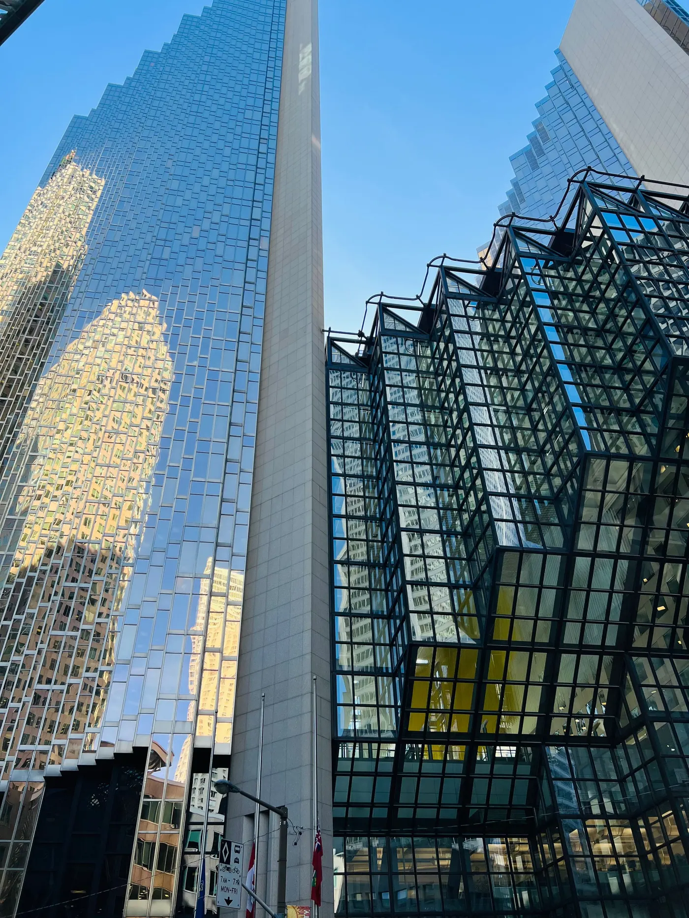 The gold mirror glass towers of Royal Bank Plaza rising beside a dark angular atrium in Toronto